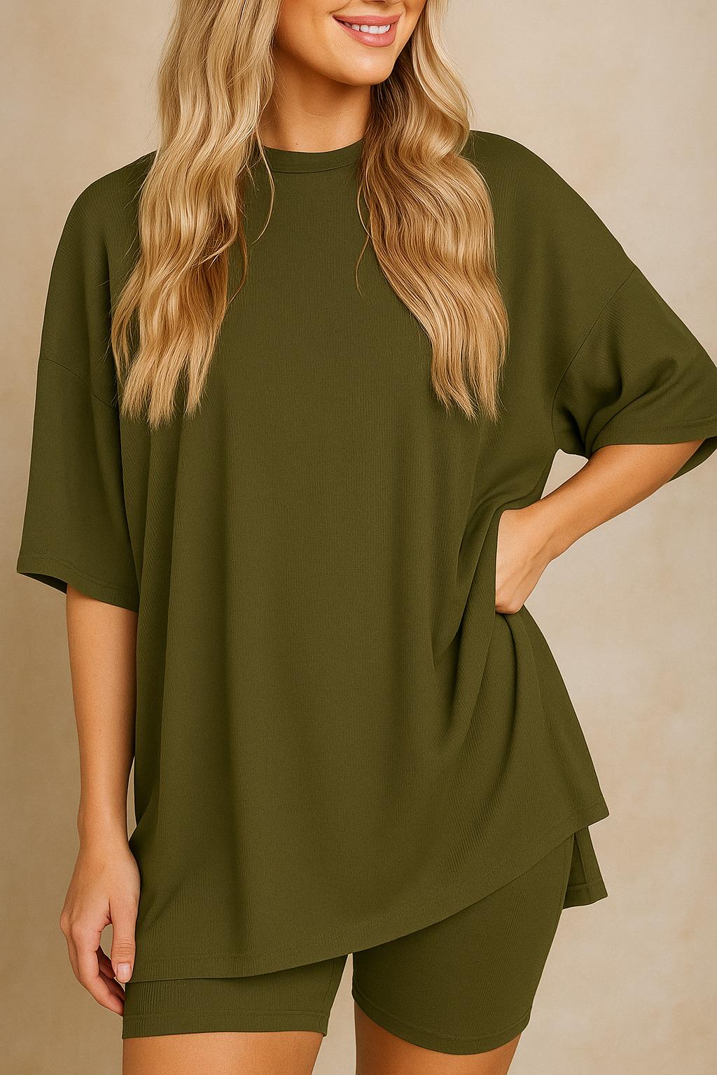 Plus size woman wearing an oversized olive green lounge set with round neck top and matching shorts