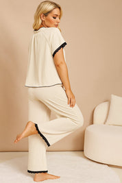 Apricot lace-trim pajama set with short-sleeve top and straight-leg pants; scalloped lace cuffs and hems visible — back three-quarter view.