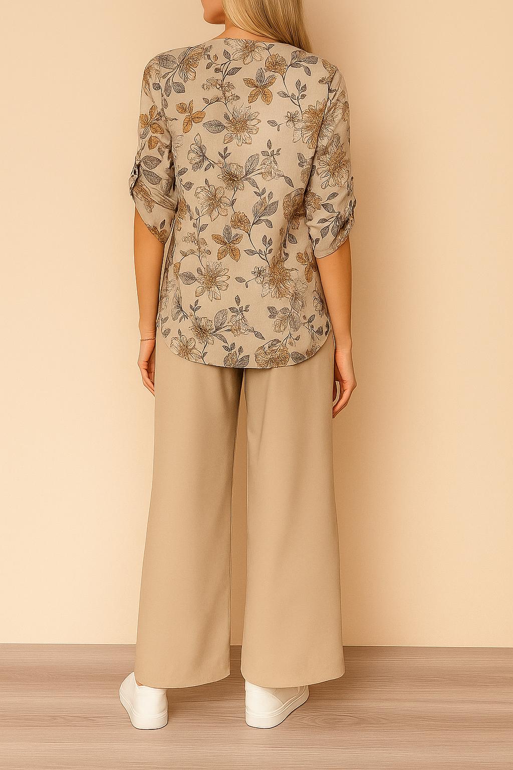 Centered back view of the apricot floral blouse with roll-tab sleeves paired with beige wide-leg pants; relaxed silhouette