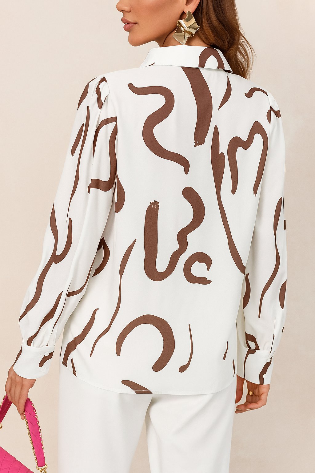 Back view of a white blouse featuring abstract brown lines, styled with statement earrings