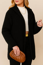 Alternate left three-quarter view of the black open-front ribbed hooded coat.