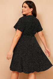 black-plus-size-polka-dot-wrap-mini-dress-clean-back-panel-ruffle-hem-back-view