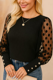 Black rib-knit blouse with sheer polka-dot sleeves and straight hem, clean back panel — back view
