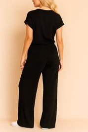 Back view of the black ribbed lounge set with straight back hem and full wide-leg silhouette.