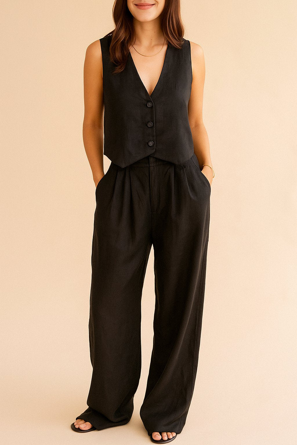 Centered front view of the black sleeveless vest with matching wide-leg pants.
