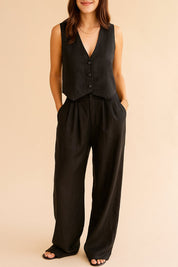 Centered front view of the black sleeveless vest with matching wide-leg pants.