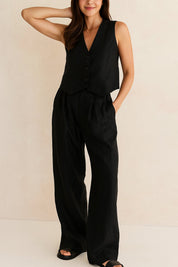 Front view of the black vest and wide-leg pants set with pleated waist and relaxed drape