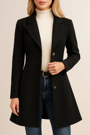 Front view of a black tailored longline coat with notched lapel, button-front and long sleeves.