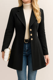 Front detail view of the black tailored longline coat highlighting the notched lapel and gold-tone buttons