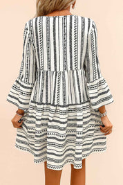 Black-and-white boho-print tie-neck mini dress with three-quarter flounce sleeves and clean back panel — back view.