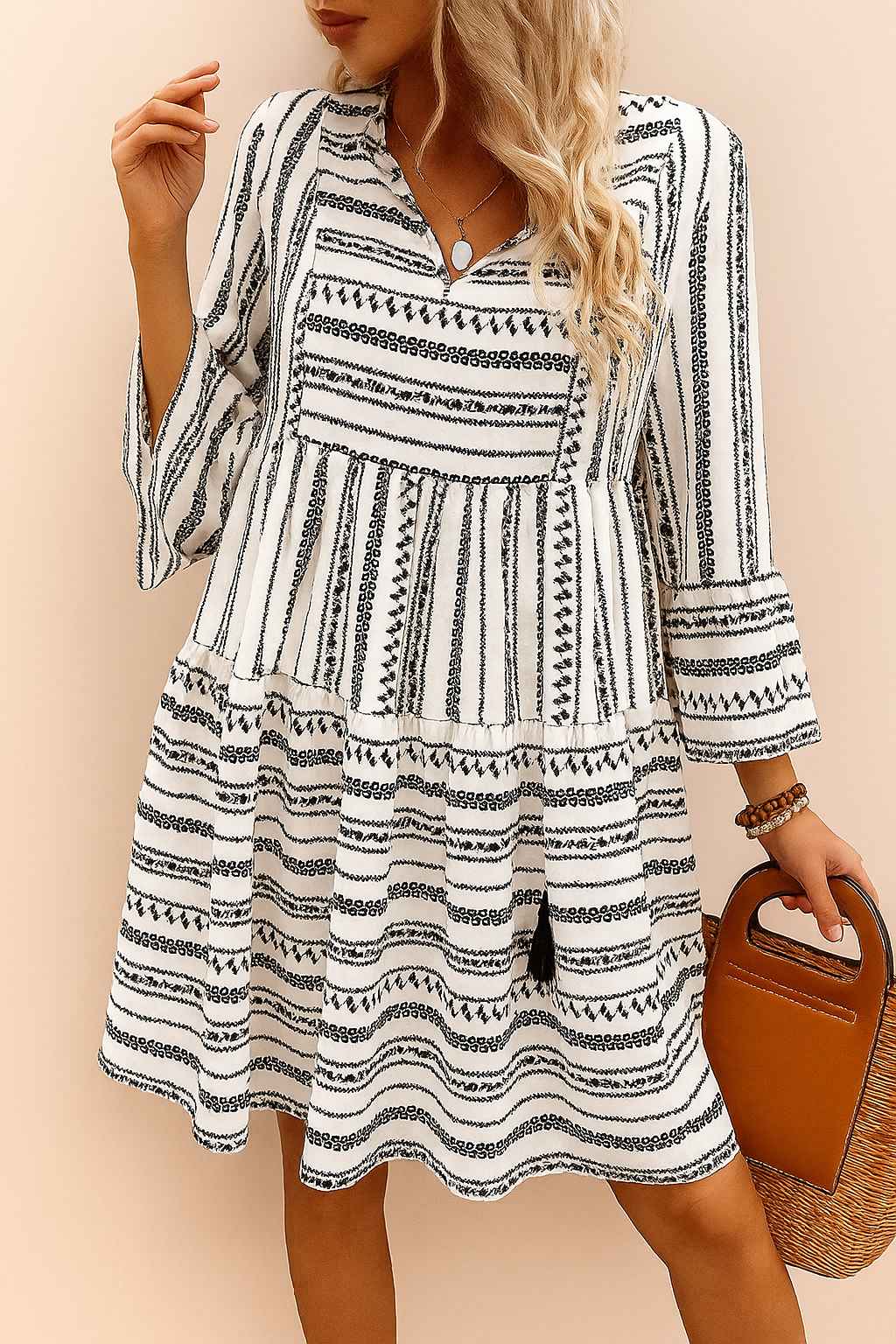 Black-and-white boho-print tie-neck mini dress with three-quarter sleeves and tiered skirt, lightweight drape — relaxed front view