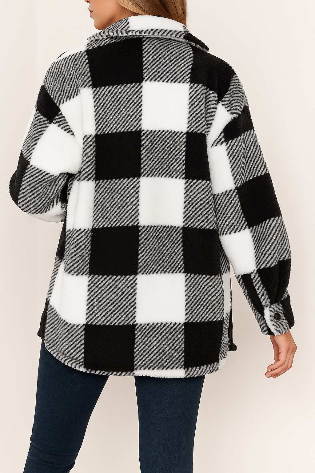 Back view of the black-and-white fuzzy plaid jacket with drop-shoulder seam and a rounded straight hem.