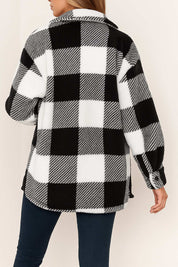 Back view of the black-and-white fuzzy plaid jacket with drop-shoulder seam and a rounded straight hem.