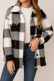 Front detail view highlighting the flap chest pocket and button placket on the black-and-white fuzzy plaid jacket.