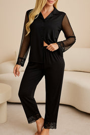 Woman in black lace-trim pajama set featuring long mesh sleeves and full-length pants, ideal for stylish sleepwear or lounging