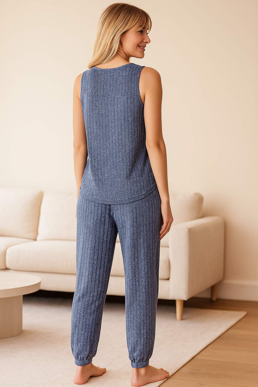 Back view of women's blue ribbed knit pajama set with sleeveless top and cuffed pants