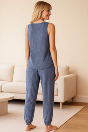Back view of women's blue ribbed knit pajama set with sleeveless top and cuffed pants