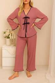 Woman wearing blush lounge set with black ribbon detail – standing, facing front