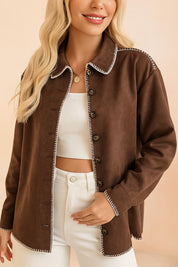 Front view of the brown faux-suede button-up shirt jacket worn open, showing the contrast whipstitch trim and long sleeves