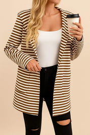 Front view of the brown-and-white striped hooded snap-button long jacket worn open; notched lapel and patch pockets visible.
