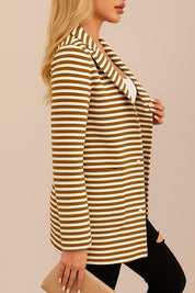 Left side view of the brown-and-white striped hooded snap-button long jacket showing the notched lapel, sleeve and patch pocket opening.