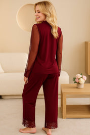Back view of a woman in burgundy pajama set with sheer dotted sleeves and lace trim pants, stylish and soft loungewear