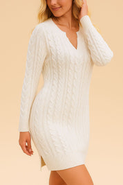Three-quarter front view of the women’s cable-knit sweater dress highlighting the V-notch neck, fitted long sleeves and body-skimming shape with a small side slit for comfort.