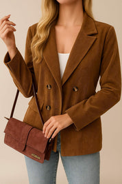 Front view of the camel brown corduroy double-breasted blazer showing the notched lapel, long sleeves and decorative flap pockets.
