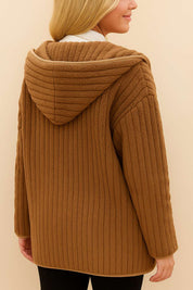 Back view of the camel brown ribbed hooded coat; hood structure and vertical ribs are visible