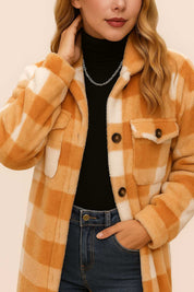 Front detail view of the camel-and-ivory buffalo-check coat highlighting the buttoned flap chest pockets and button placket.