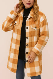 Front view of the camel-and-ivory buffalo-check button-front coat; shirt collar, long sleeves, flap chest pockets and patch pockets are visible.