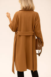 Front view of the caramel tie-waist coat with notched lapel and covered buttons; drop-shoulder sleeves and relaxed drape.
