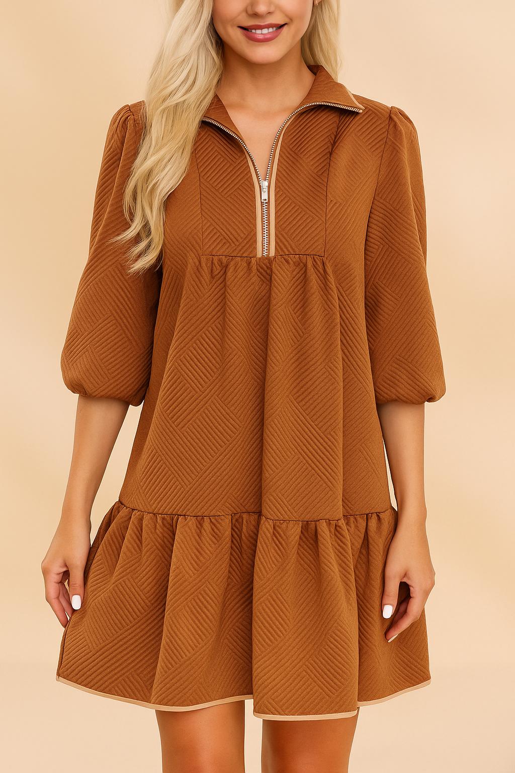 Front view of a women’s chevron-textured mini dress with a collared half-zip neckline, soft puff three-quarter sleeves and a drop-waist ruffle hem, creating a relaxed A-line swing silhouette.