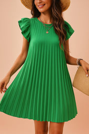Close-up of pleated green dress with layered necklace and ruffle sleeve detail