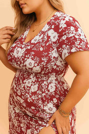 Close-up of red floral plus-size maxi dress with V-neckline and smocked waist, showing soft fabric texture and flattering fit on curvy silhouette.