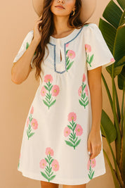 Cream floral-print mini dress with flutter sleeve shape and gentle A-line sway — left three-quarter view