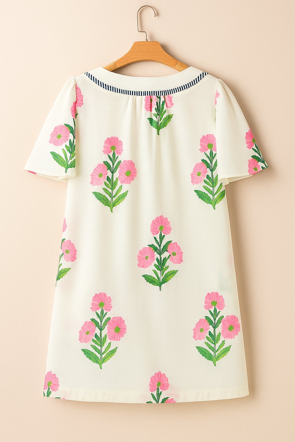 Cream floral-print mini dress with soft back neckline and straight hem — hanger back view.
