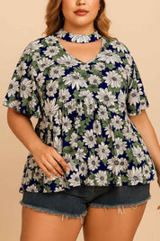 Close front detail of the dark blue floral blouse highlighting the cutout choker neckline, V notch and gathered front.