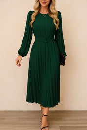 Dark-green belted pleated long-sleeve midi dress with crew neckline and covered buckle belt — centered front view