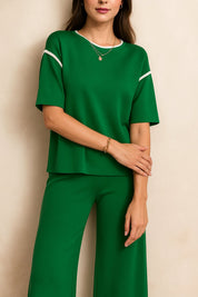 Front detail view of the Dark Green lounge top showing the neckline piping and sleeve trim