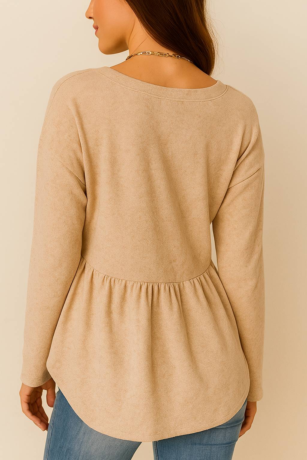 Back three-quarter view of the dust-storm beige V-neck button-front top with drop-shoulder sleeves and rounded hem