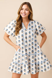 Women’s dusty-blue floral-embroidered cotton babydoll mini dress with puff sleeves, tiered skirt and side pockets — front view
