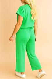 Front pocket detail of the green ribbed lounge set showing side pocket entry, ribbed texture and the drawstring waistband slightly in frame