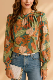 Green tropical leaf-print long-sleeve blouse with billowy sleeves and relaxed drape — front three-quarter view