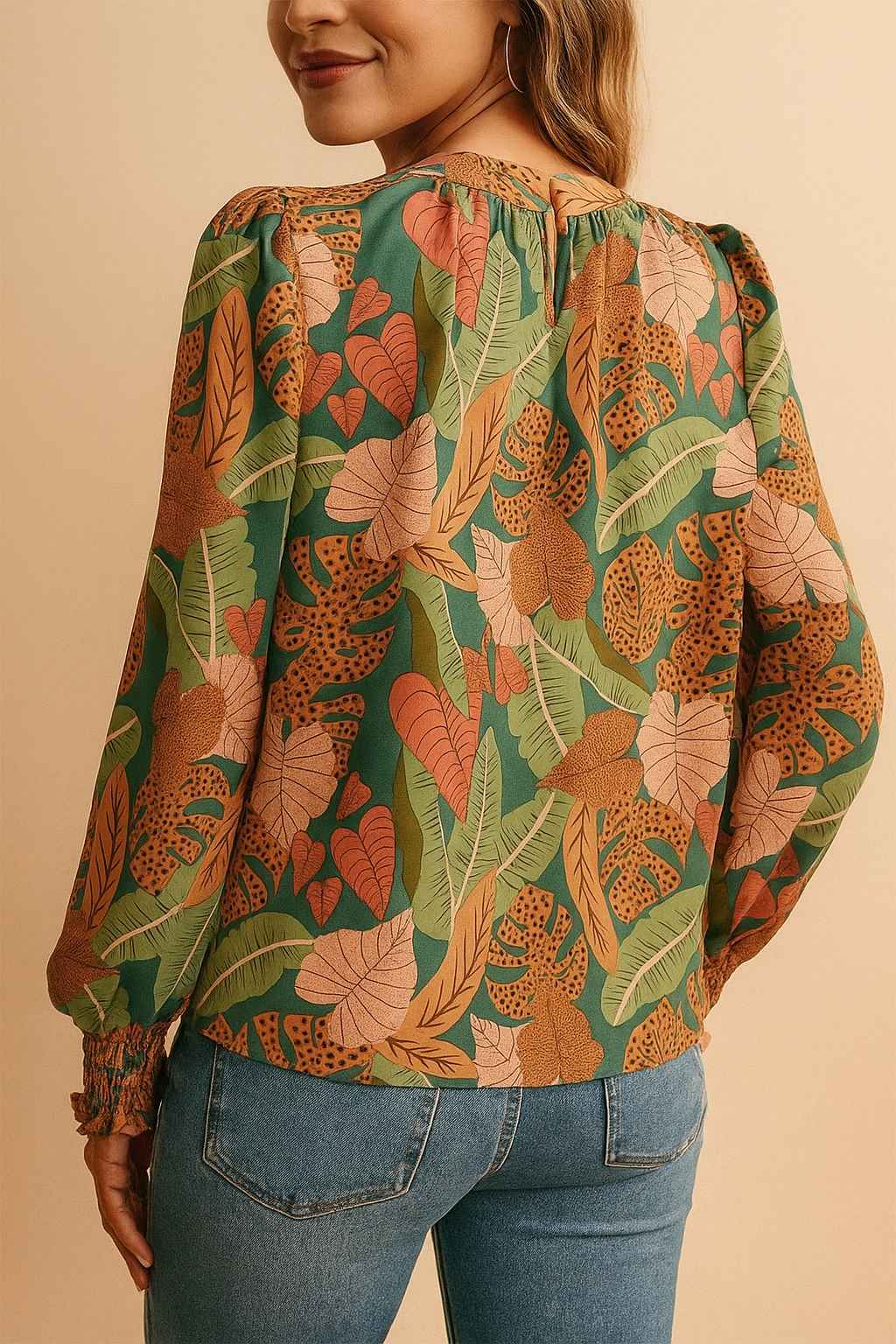 Green tropical leaf-print long-sleeve blouse with smocked cuffs and lightly puffed sleeves — right three-quarter view