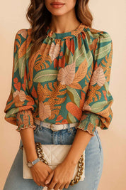 Green tropical leaf-print long-sleeve blouse with straight hem and easy relaxed fit — centered front view.