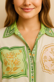 Front detail view of the ivory-multi set highlighting the shirt collar, button placket and ornamental print panels with green edging.