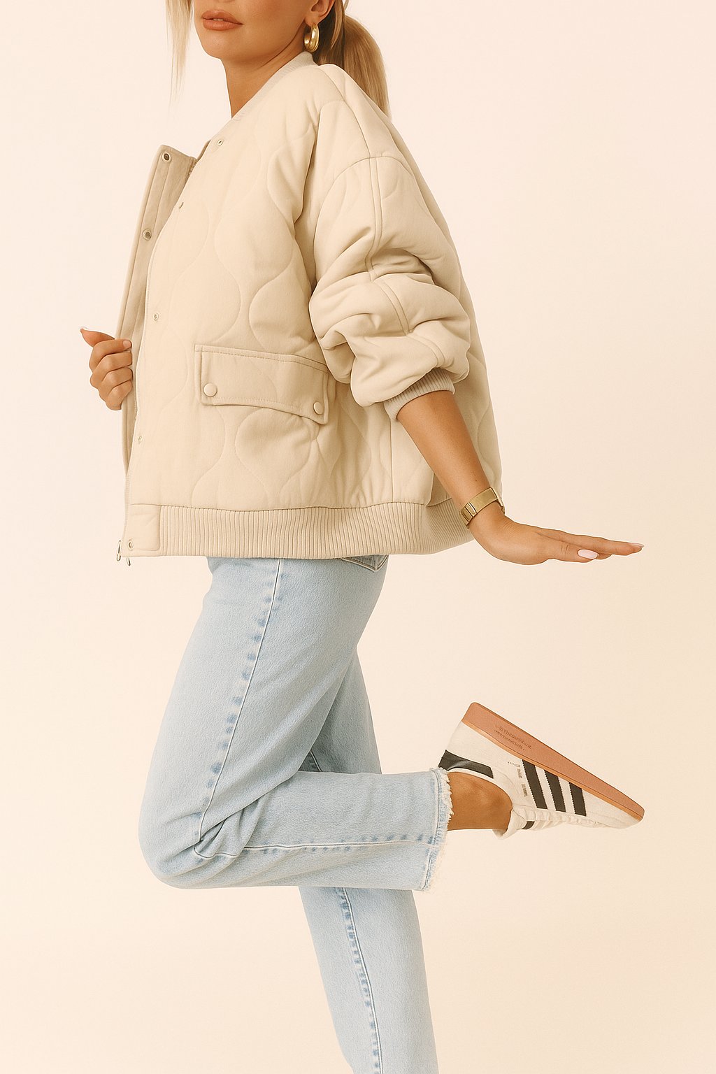 Left side view of the ivory quilted bomber jacket showing rib-knit trims, curved quilting and a snap-flap pocket