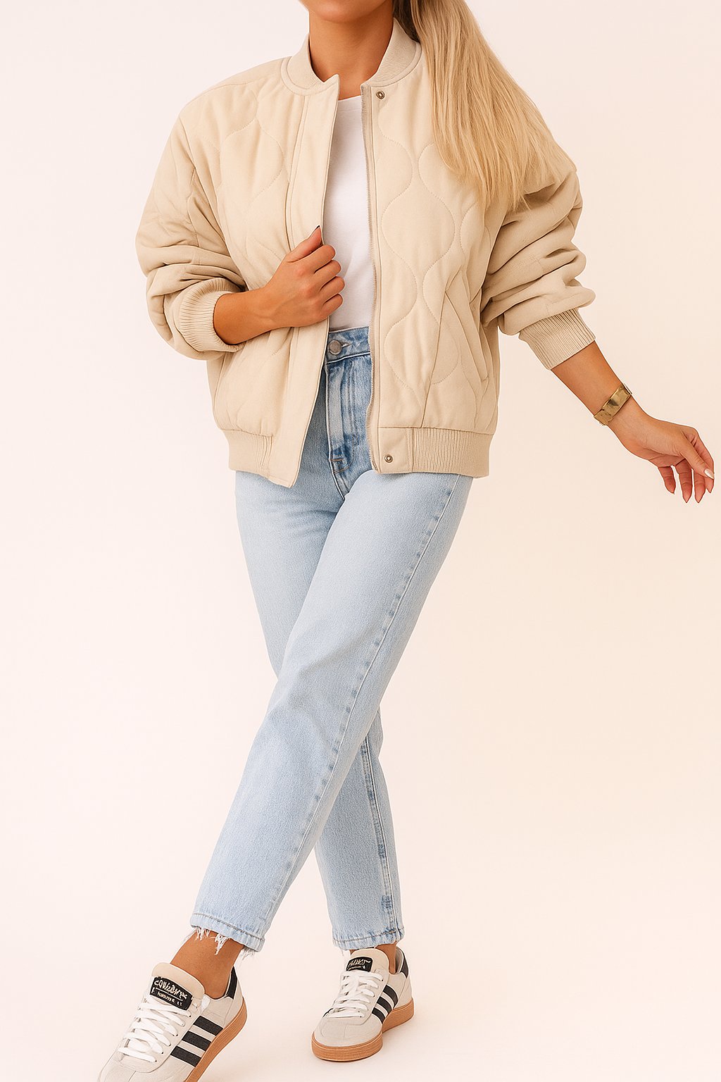 Front view of the ivory quilted bomber jacket with rib-knit collar, zip front covered by a snap-button placket, and snap-flap pockets
