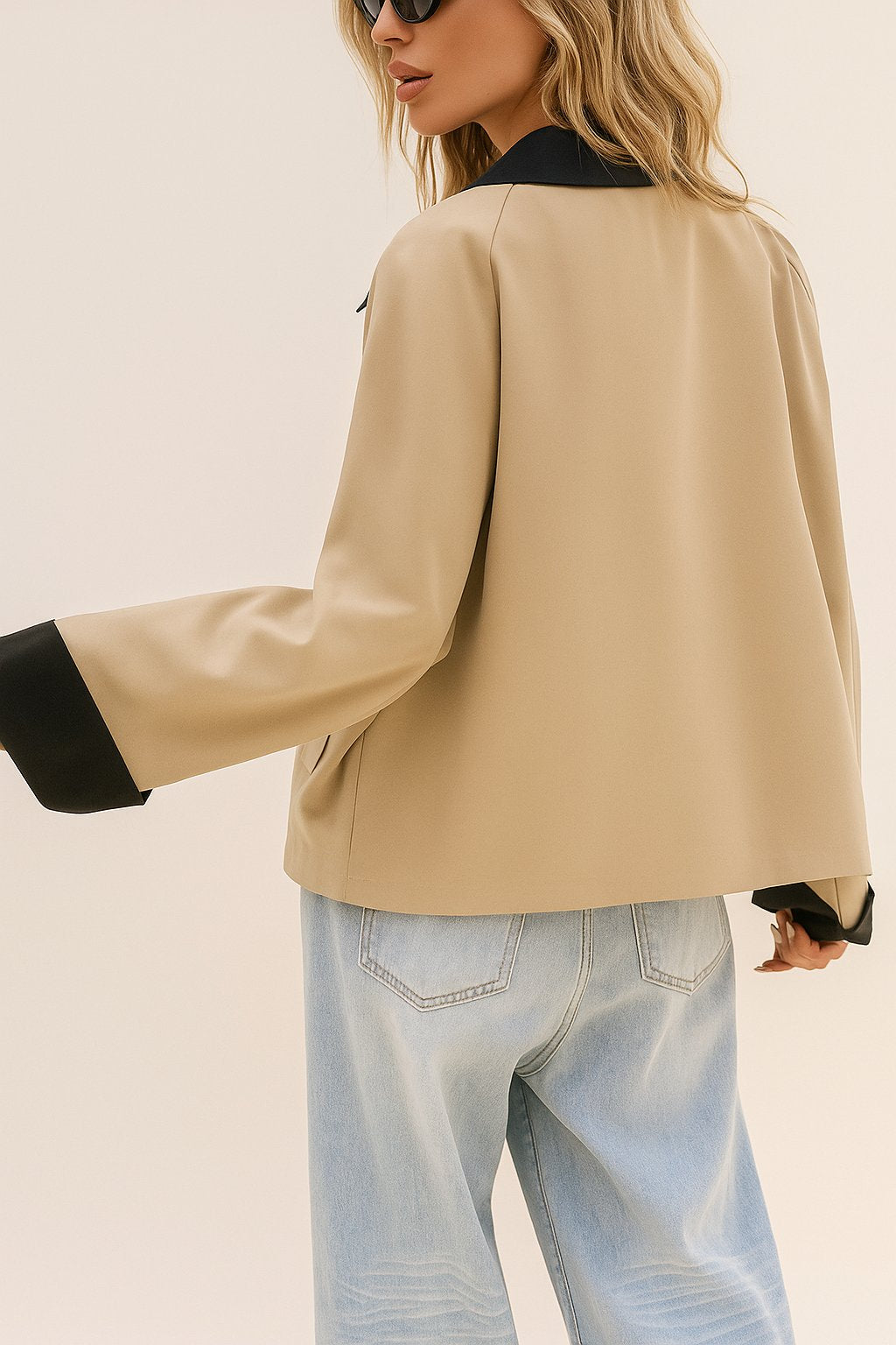 Back three-quarter view of the khaki color-block button-up jacket showing the black contrast collar and cuff accents and straight hem